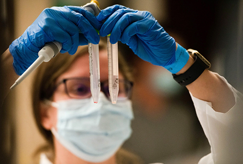 Women looking at test tubes