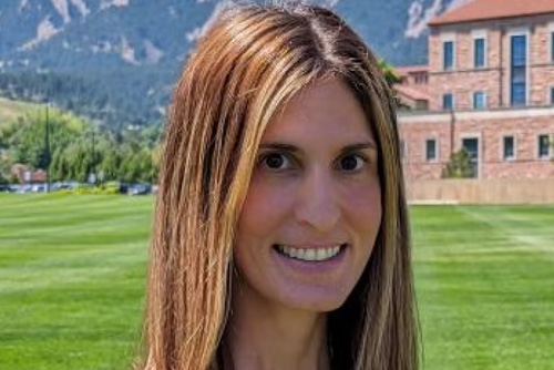 A photo of Theodora Chaspari on the CU Boulder campus with the Flatirons in the background