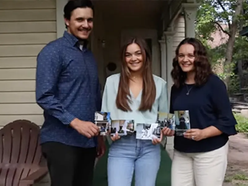 Siblings Jacob Lobato, Alyssa Lobato, and Katelyn Puga stand in the historic 9th Street neighborhood holding family photos
