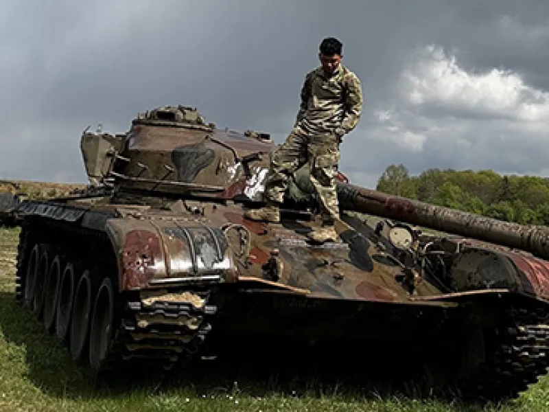 Xavier Roman stands atop a tank