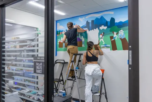 Students work on a new mural of CU Denver for Milo's Market food pantry
